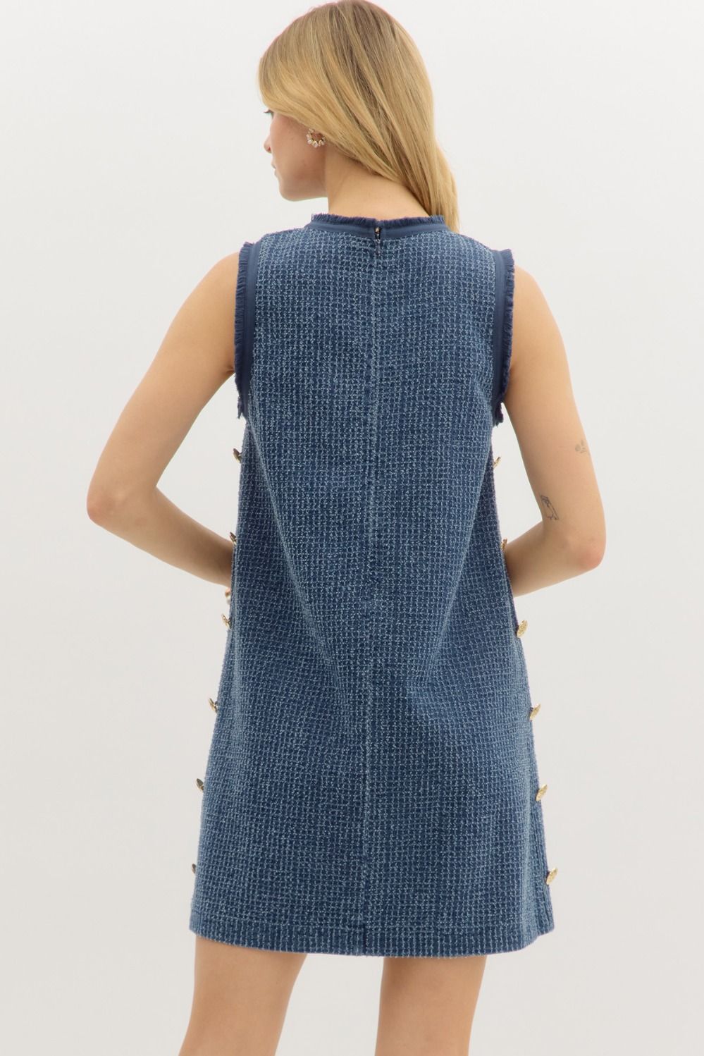 Denim distressed sleeveless mini dress featuring gold accent buttons along side.