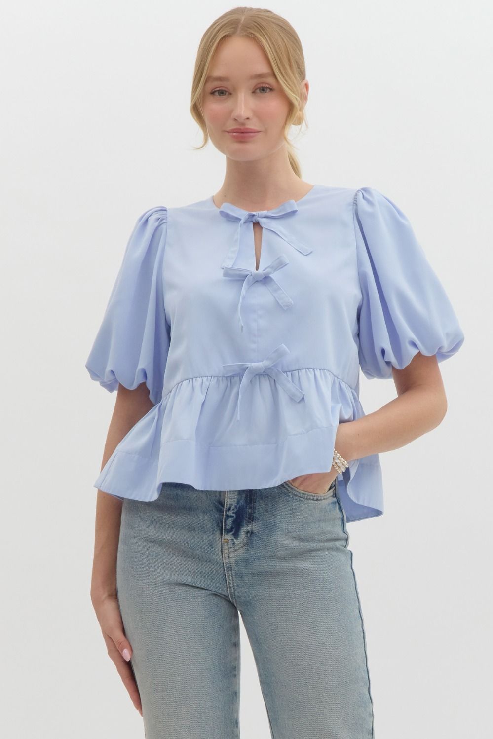 Baby Blue Solid short puff sleeve peplum top featuring self-tie bow detail at front