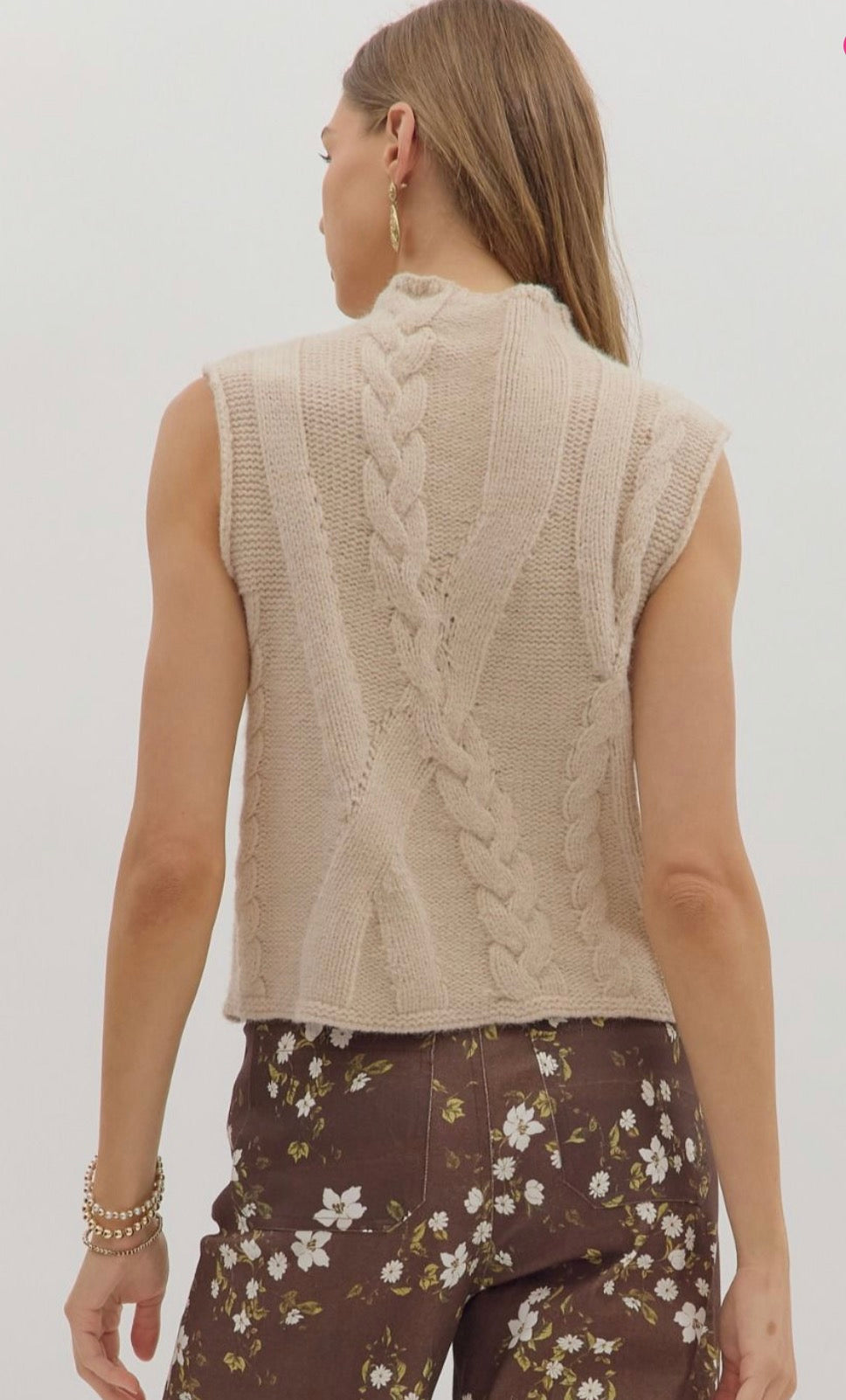 Solid sleeveless mock neck sweater knit top featuring cable knit texture