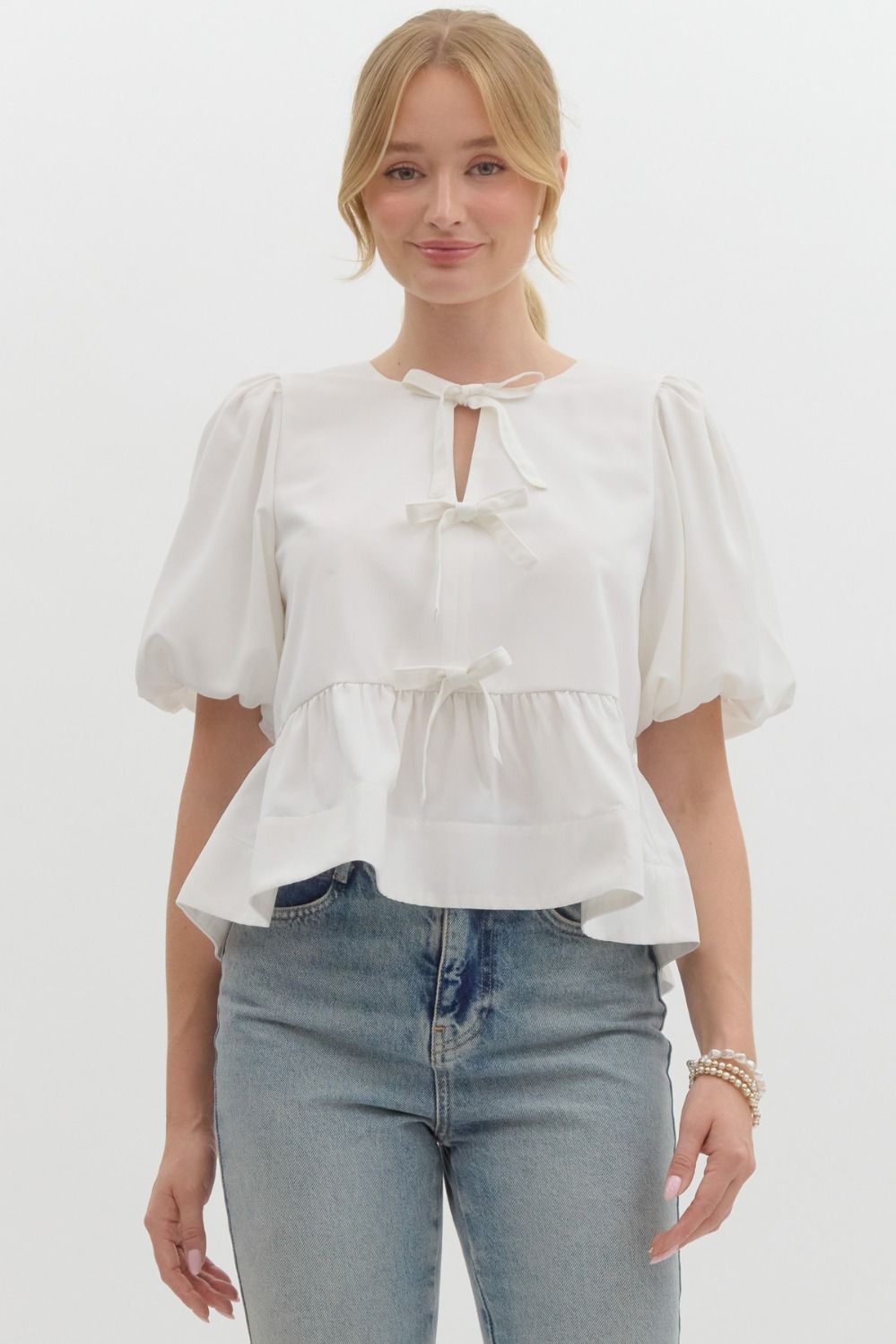 Off White Solid short puff sleeve peplum top featuring self-tie bow detail at front