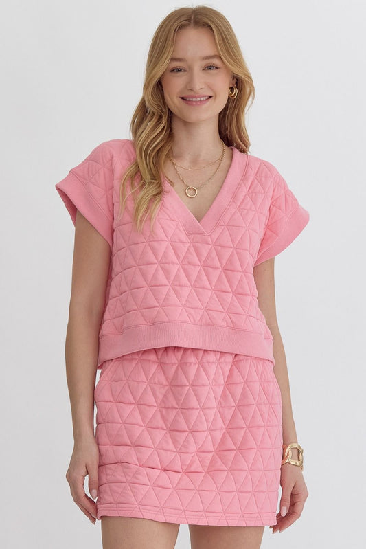 Textured v-neck short sleeve cropped top. Unlined. Knit. Non-sheer. Mediumweight. Light pink