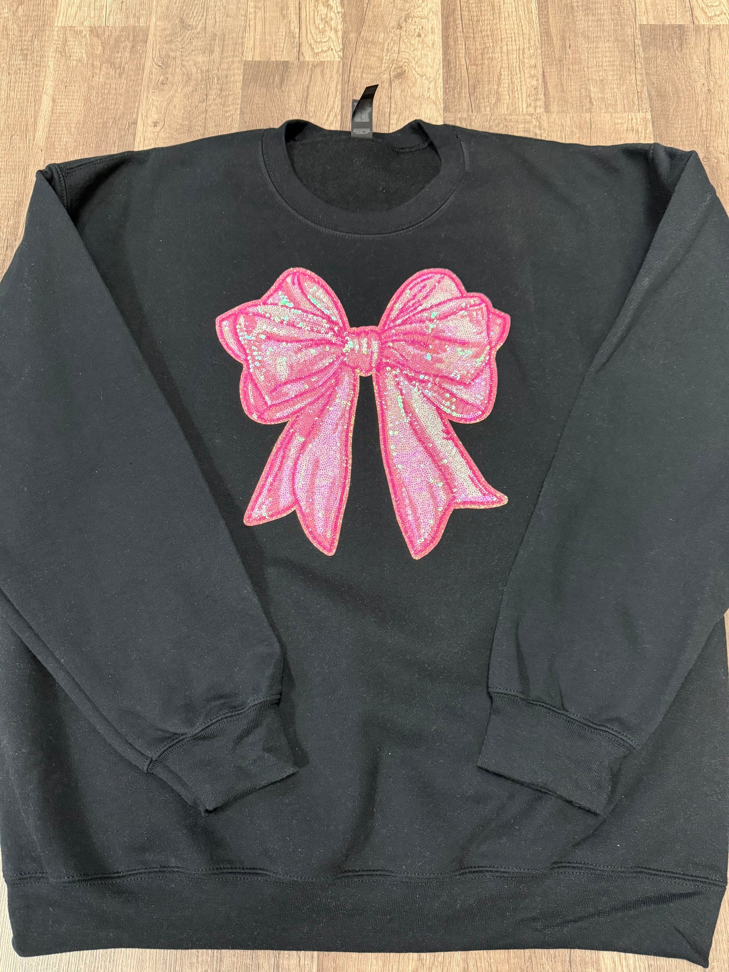 Pink sequin bow patch sweatshirt on black