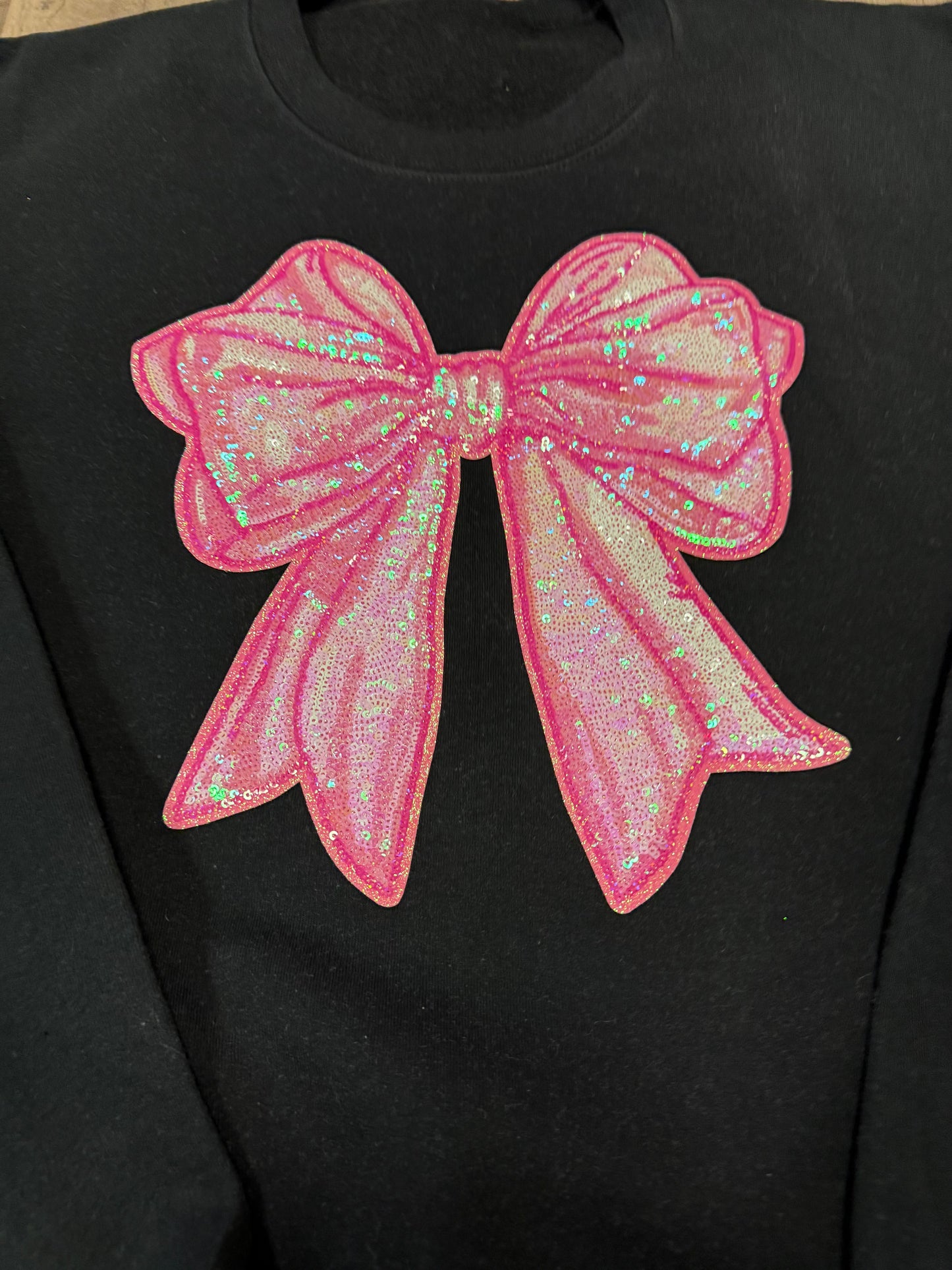 Pink sequin bow patch sweatshirt on black