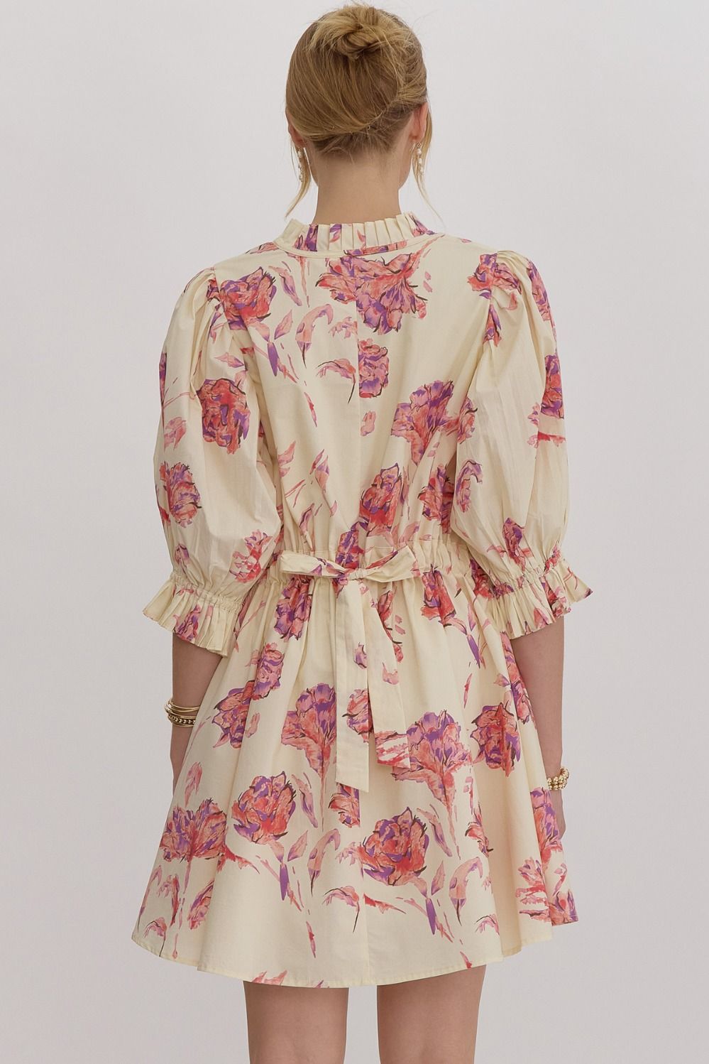 Floral print puff sleeve mini dress featuring adjustable self tie at back.