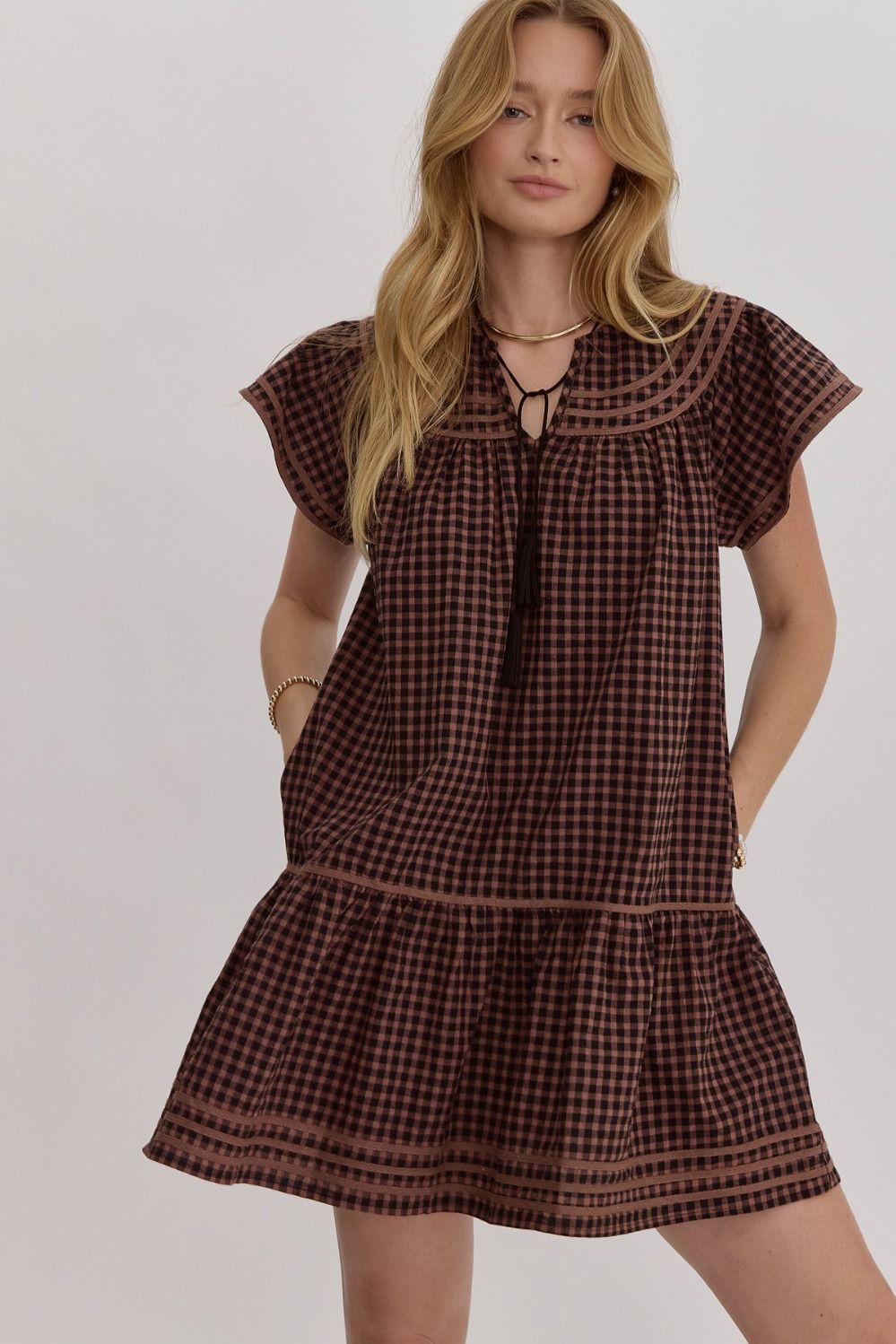 Gingham v-neck short sleeve mini dress featuring solid trim.