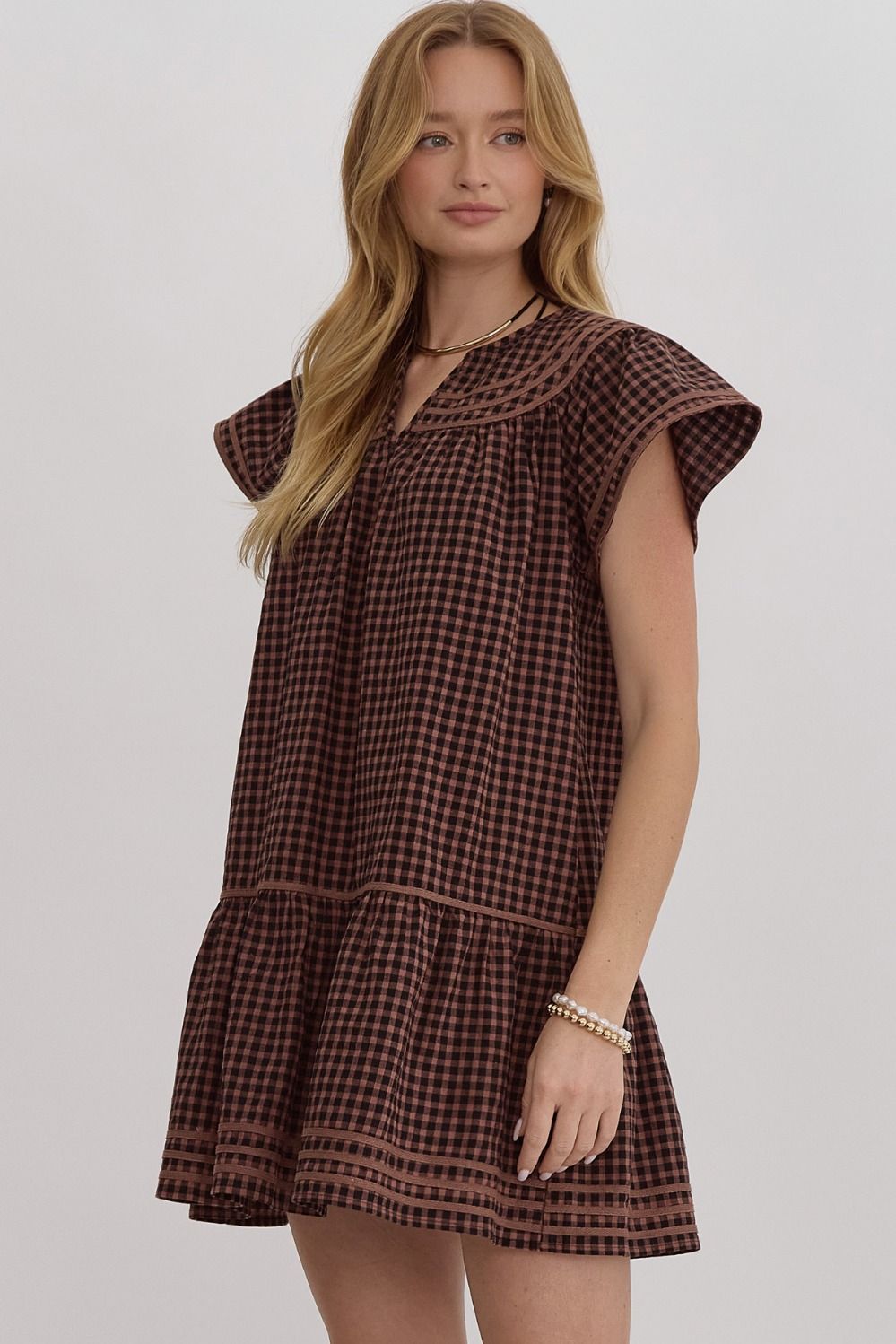 Gingham v-neck short sleeve mini dress featuring solid trim.