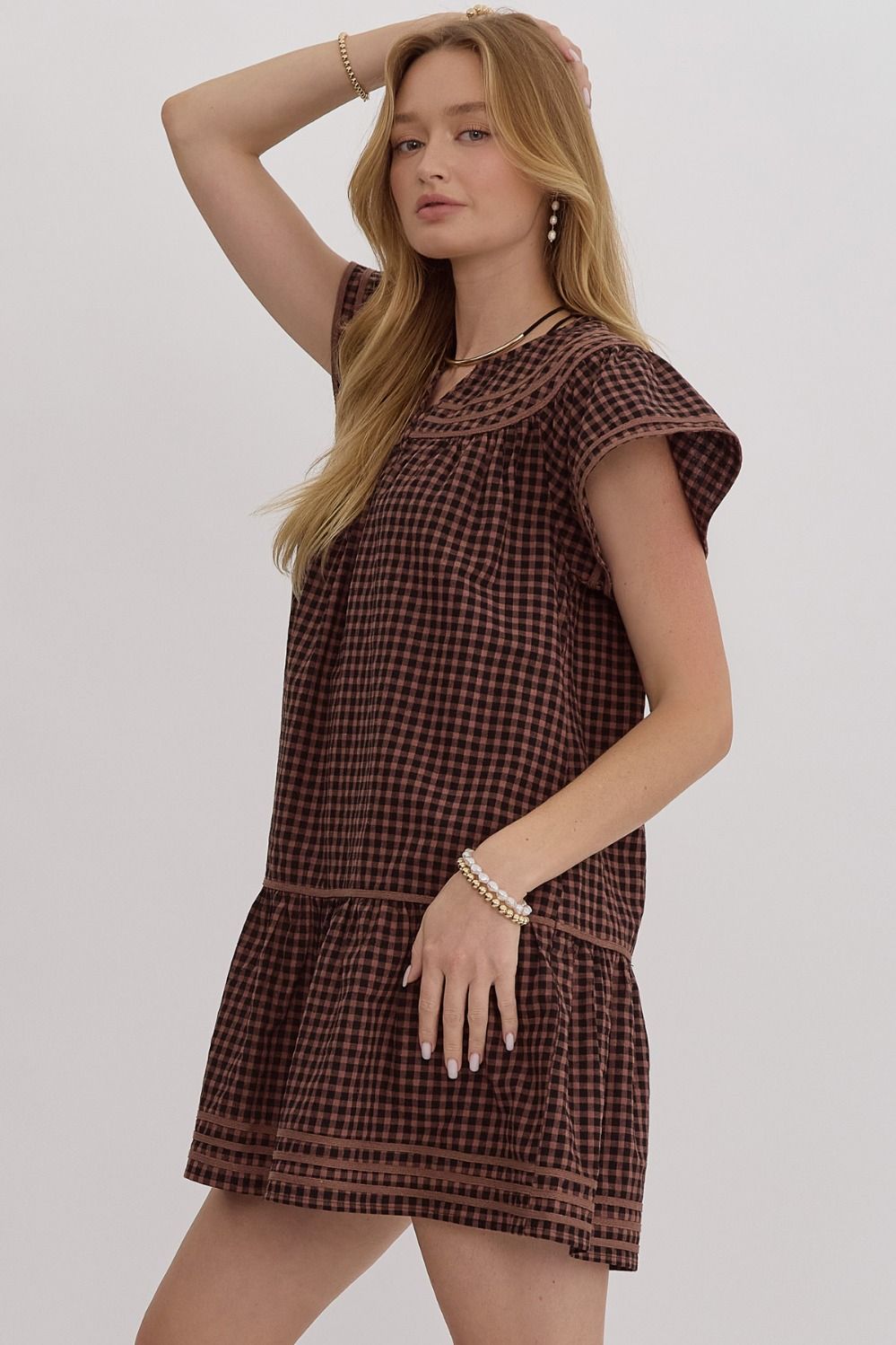 Gingham v-neck short sleeve mini dress featuring solid trim.