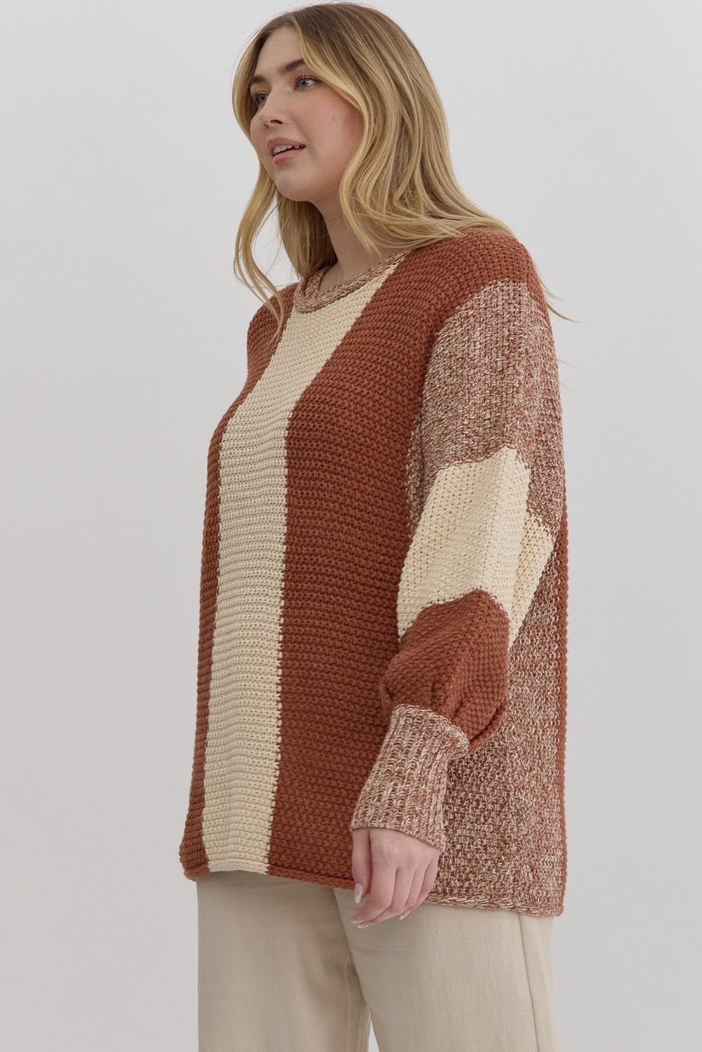 Colorblock knit cropped bubble sleeve sweater featuring ribbed cuffs.