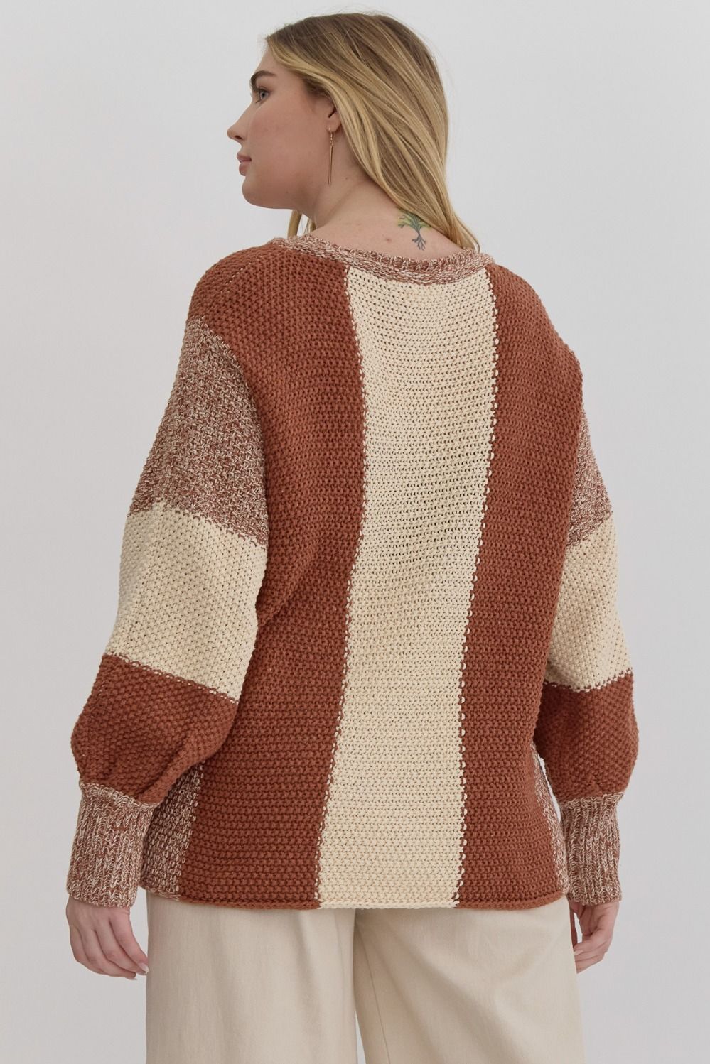 Colorblock knit cropped bubble sleeve sweater featuring ribbed cuffs.